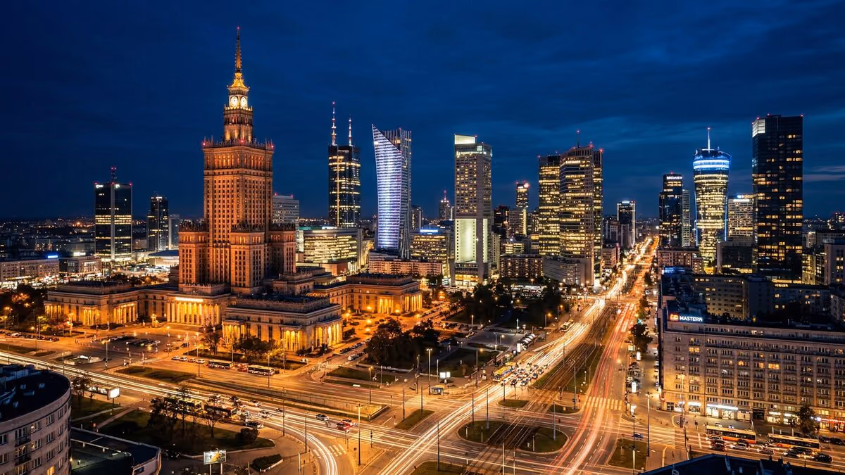 Warsaw's city centre at night, with the Palace of Culture and Science among lit office towers